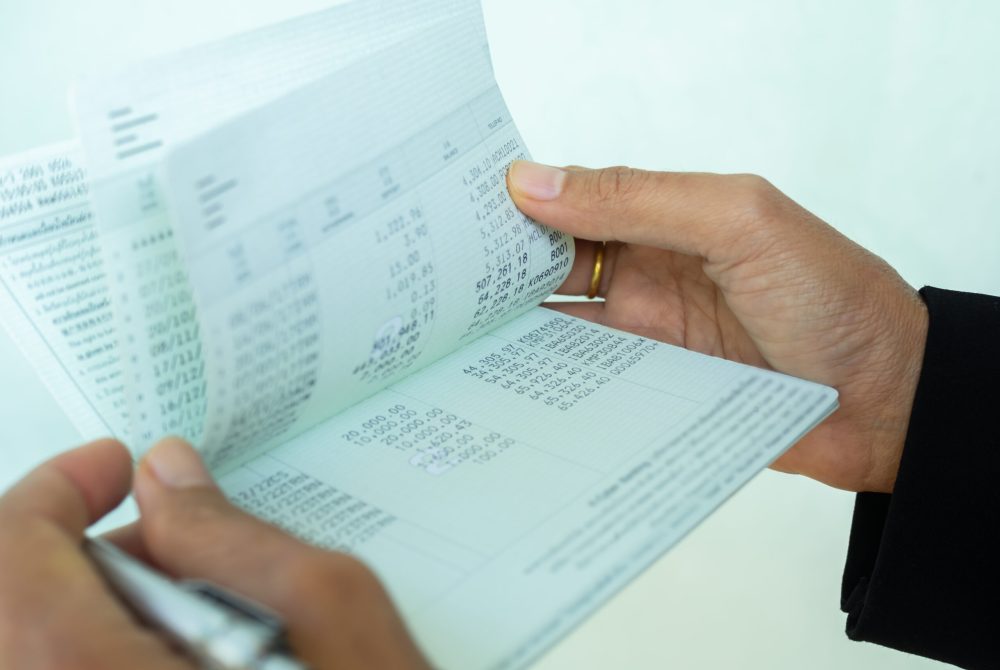 Bank account book statement balance number cash, hand holding da Bank account book statement balance number cash, hand holding data investment debt math in office, bill receipt and payment business credit card account, check paper financial loan tax concept.